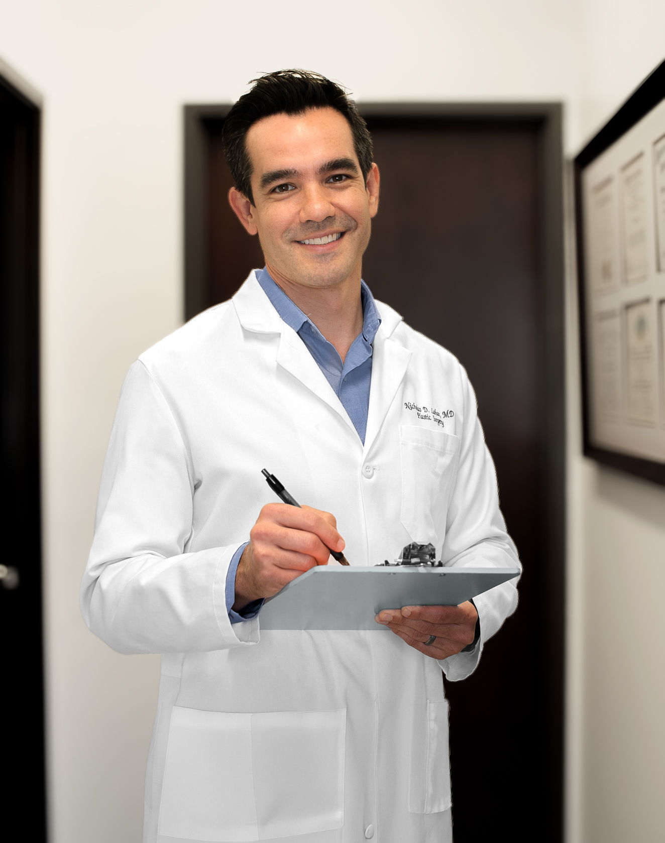 Dr. Nicholas Lahar holding a clipboard in the clinic